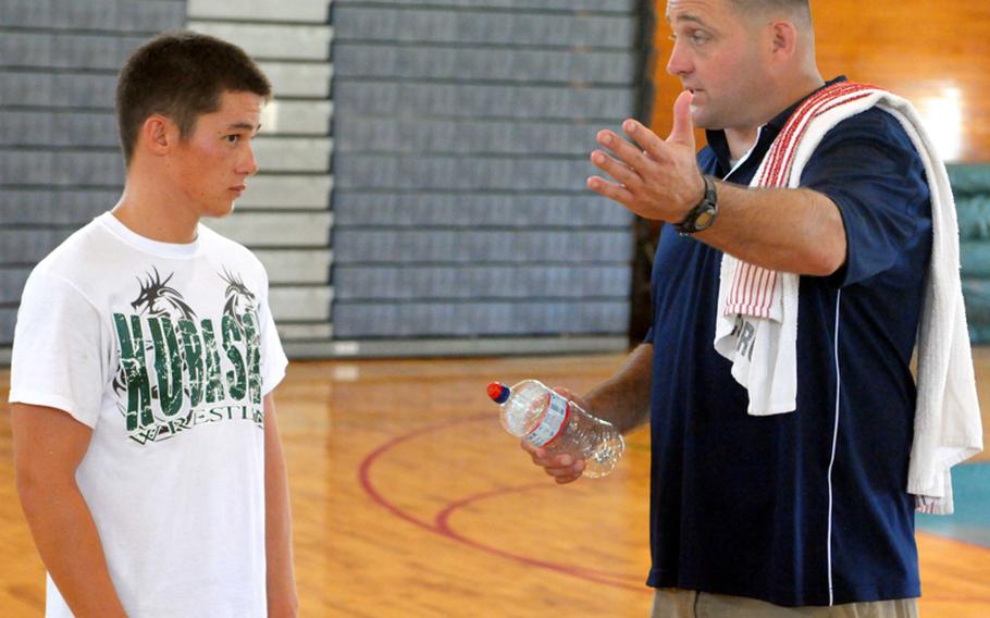 All-Marine wrestling coach Dan Hicks chats it up with Kubasaki High School senior 129-pound wrestler Kevin Orr during a break in the action of Saturday's Camp Schwab Open wrestling tournament. Hicks visited the tournament to scope out potential candidates for inclusion on the All-Marine team, which will wrestle in the All-Armed Forces tournament in November.