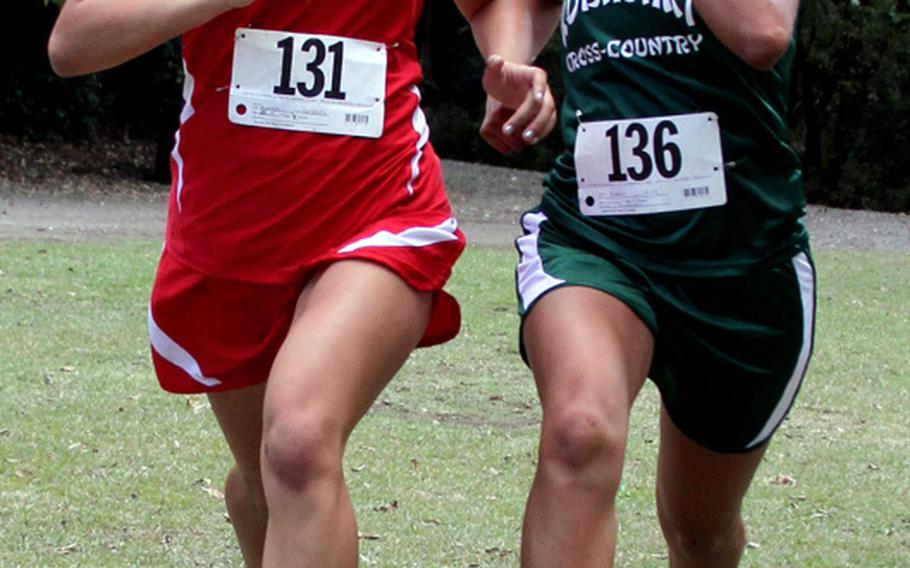 DODDS Japan cross-country champion Carydaliz Fontanez of Nile C. Kinnick and Okinawa Activities Council island champion Alle Robles of Kubasaki Dragons pound for the finish line in the Far East High School Cross-Country Meet 3.1-mile individual gold medal at Tama Hills Recreation Center, Tokyo on Monday, Nov. 7, 2011. Fontanez took sixth and Robles seventh, just .3 seconds apart, Fontanez in 22 minutes, 8.0 seconds and Robles in 22:08.3.