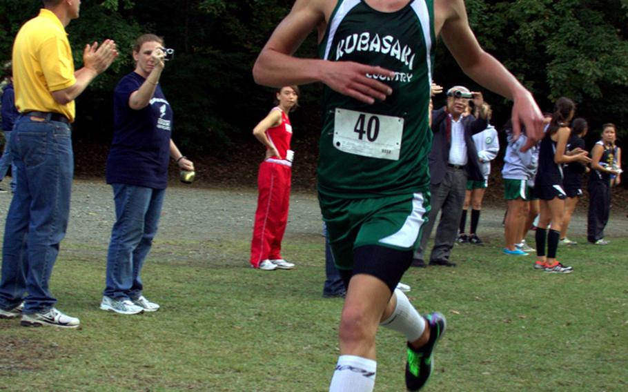 Kubasaki Dragons freshman Erik Armes crosses the finish line to win his first Far East High School Cross-Country Meet 3.1-mile individual gold medal on Nov. 7, 2011, at Tama Hills Recreation Center, Tokyo. Armes was clocked in 17 minutes, 42.2 seconds. He helped Kubasaki win the boys team title, the school's first of any kind in a Far East cross-country meet since the boys also won in 2000, also at Tama Hills. Kubasaki after one day of the two-day meet was the leader in the chase for the overall team banner, which would be the first in school history.