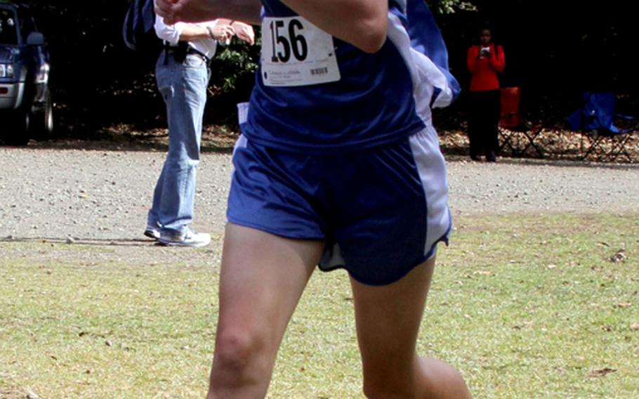 Seoul American Falcons senior Amanda Henderson crosses the finish line in 20 minutes, 55.5 seconds to capture her second straight Far East High School Cross-Country Meet 3.1-mile individual gold medal on Nov. 7, 2011, at Tama Hills Recreation Center, Tokyo. Henderson finished the last two seasons 40-0 and helped lead the Falcons to their second straight girls team title.