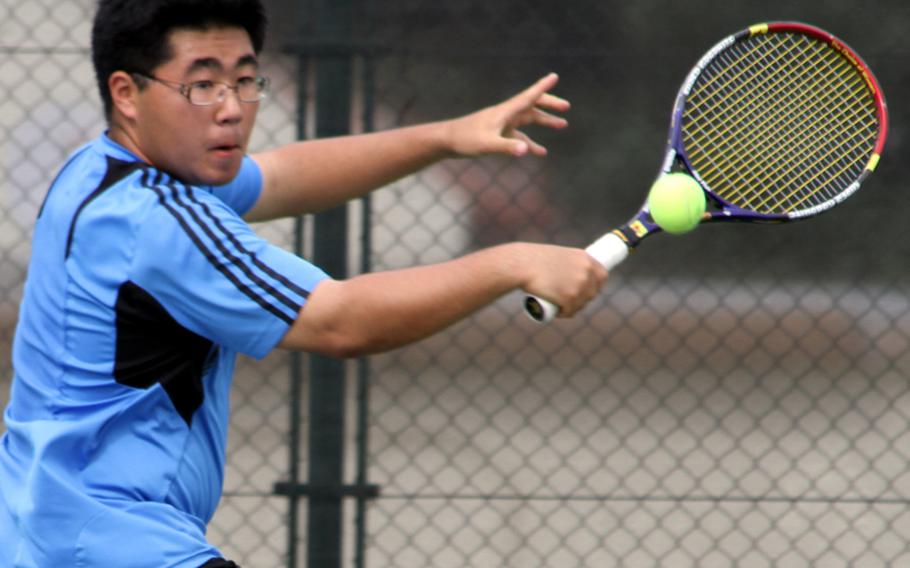 Jong Uk Sin of Osan American reaches for a backhand during the first-round play in the 2011 Far East High School Tennis Tournament at Risner Tennis Complex, Kadena Air Base, Okinawa on Nov. 7, 2011. Sin lost 8-2 to Taishi Misumi of St. Mary's International in the boys singles, then lost with teammate Alec Myers in the boys doubles 8-4 to Alex Daniels and Michael Potts of Kadena.