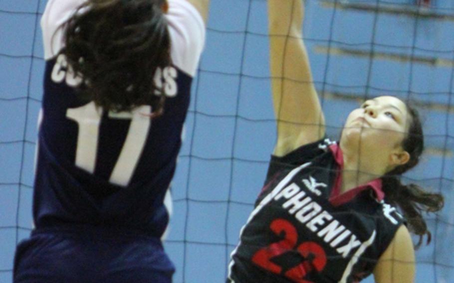 Nico McGuire (22) of Seisen International tries to spike through the block of Alixes Scott (17) of Academy of Our Lady of Guam during the pool-play match in the 2011 Far East High School Girls Division I (large schools) Volleyball Tournament at Falcon Gym, Seoul American High School, South Post, Yongsan Garrison, South Korea on Nov. 7, 2011.  Seisen won in straight sets.