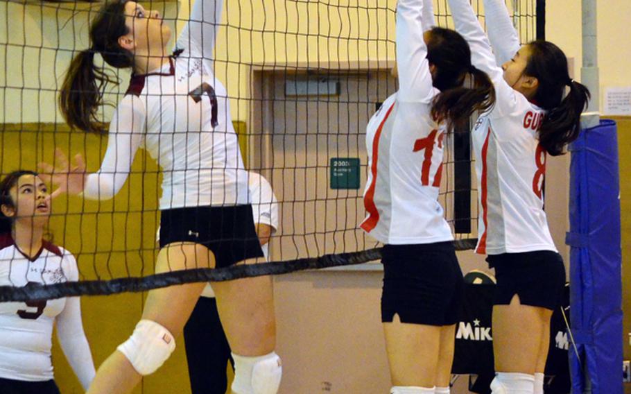 Matthew C. Perry's Courtney Beall tries to send a shot through a double block by Yongsan International-Seoul during the pool-play match in the 2011 Far East High School Girls Division II (small schools) Volleyball Tournament at Warrior Gym, Daegu American School, Camp George, South Korea on Nov. 7, 2011. YIS-S swept the Samurai in three sets.