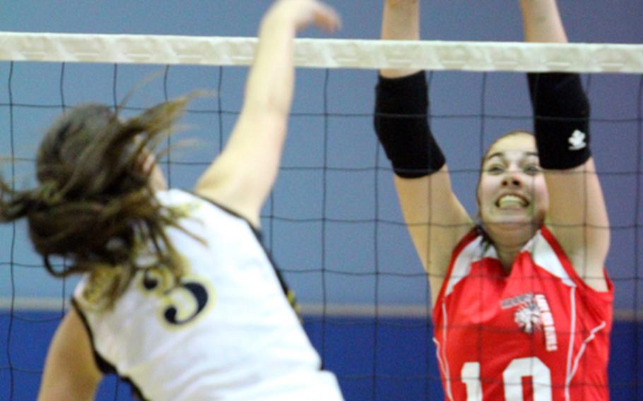 Nile C. Kinnick Red Devils middle blocker Emily Stith tries to stop American School In Japan Mustangs' Elena Wadden (3) during the division play match in the 2011 Far East High School Girls Division I (large schools) Volleyball Tournament at Falcon Gym, Seoul American High School, South Post, Yongsan Garrison, South Korea on Nov. 8, 2011. ASIJ won in straight sets.