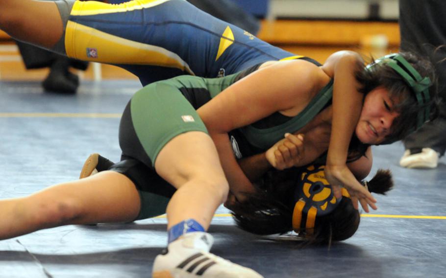 Daegu High's Christina Thompson and Guam High's Victoria Davis battle for the advantage during the 101-pound pool-play bout on Feb. 13, 2012, in the 35th Far East High School Wrestling Tournament at Yokosuka Naval Base, Japan. Davis pinned Thompson in 2 minutes, 52 seconds.
