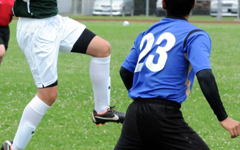 Kubasaki Dragons' Kai Stallings (17) heads the ball in front of a Shuri defender during the high school boys soccer match March 11, 2012, 
at Kubasaki High School, Camp Foster, Okinawa. Shuri won 5-1.