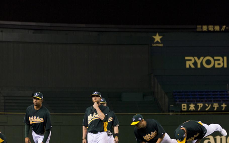 The Oakland Athletics warm up Saturday before practicing at the Tokyo Dome in Tokyo.