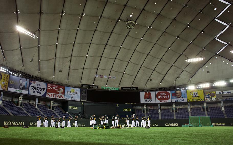 The Oakland Athletics warm up before practicing Saturday at the Tokyo Dome in Tokyo.