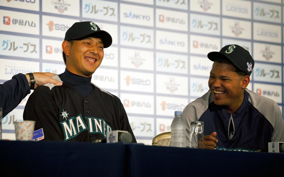 Seattle Mariners pitchers Hisashi Iwakuma, left, and Felix Hernandez laugh during a press conference Saturday at the Tokyo Dome Hotel in Tokyo.
