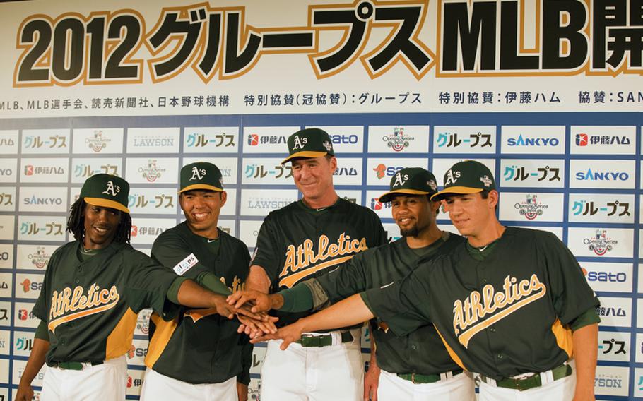 Oakland Athletics second baseman Jemile Weeks, catcher Kurt Suzuki, manager Bob Melvin, outfielder Coco Crisp and pitcher Tommy Milone pose for a photo following a press conference Saturday at the Tokyo Dome Hotel in Tokyo. 