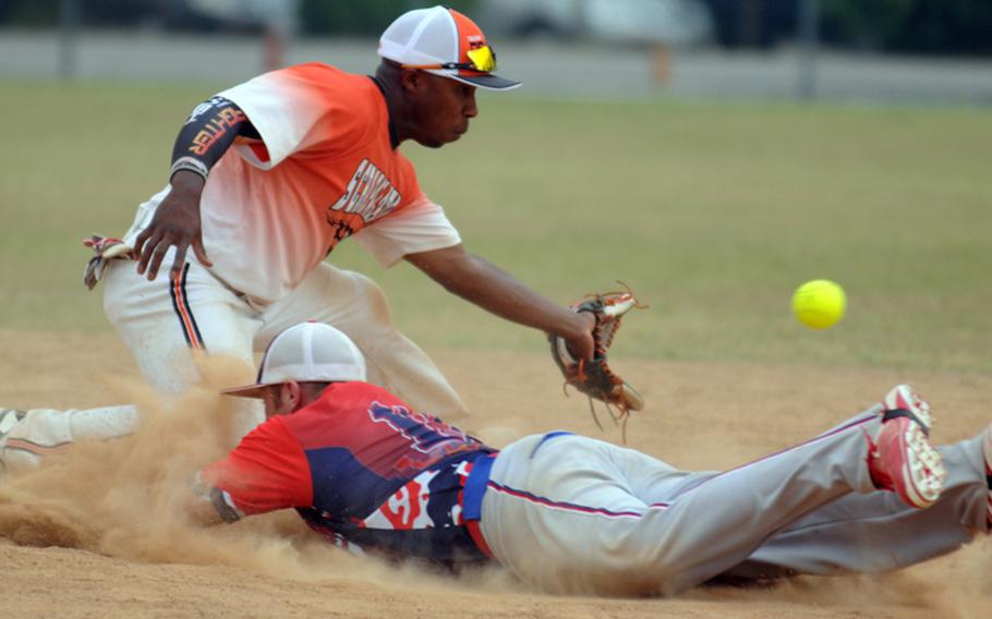 Scrapalators shortstop Maikled Quarles gets the throw from the outfield too late to nail sliding American Legion baserunner Tommy Melton at second base during the men's open championship game May 28, 2012, in the 22nd Pacificwide Open Softball Tournament Yongsan Garrison, South Korea. Scrapalators repeated their title, beating Legion 50-36 and 38-36.