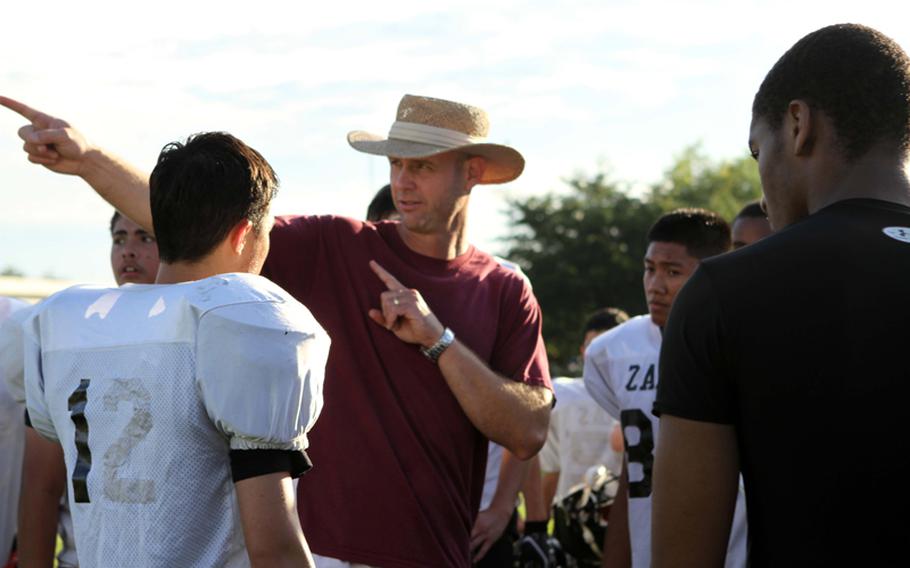 Coach Steven Merrell makes his point during football practice Aug, 14, 2012, at Zama American High School.