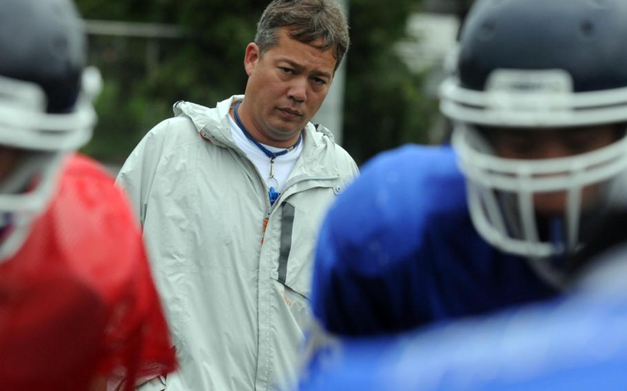 Seoul American Falcons football coach Jim Davis eyes his charges during practice Aug. 20, 2012, at Seoul American High School, South Korea.