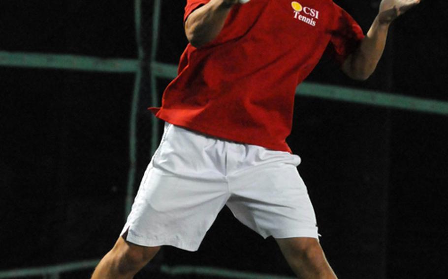 Junior Kei Tokeshi of Okinawa Christian School International slams a forehand volley against Dale Tubat of Kubasaki in the boys final in the Okinawa Activities Council district singles tennis tournament Oct. 29, 2012, at Kadena Air Base Okinawa. Tokeshi became the first OCSI player to win both a doubles and singles OAC district title, beating Tubat 8-0 five days after winning the district doubles title with teammate James Durham.