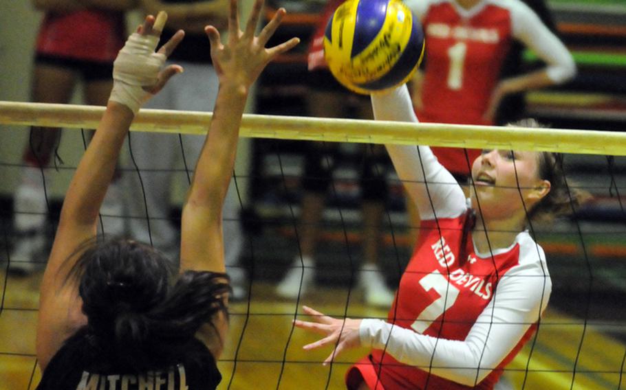 Nile C. Kinnick Red Devils outside hitter Michayla Robinson smacks a spike kill against Seisen International Phoenix middle blocker Keila Mitchell during Tuesday's Kanto Plain Association of Secondary Schools girls volleyball match at the Phoenix Center, Seisen International School, Tokyo. Kinnick won in five sets, 25-18, 25-14, 21-25, 19-25, 15-11.