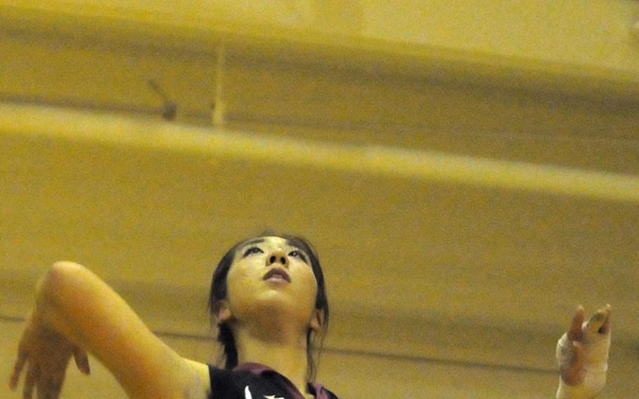 Seisen International Phoenix middle blocker Keila Mitchell serves against the Nile C. Kinnick Red Devils during Tuesday's Kanto Plain Association of Secondary Schools girls volleyball match at the Phoenix Center, Seisen International School, Tokyo.