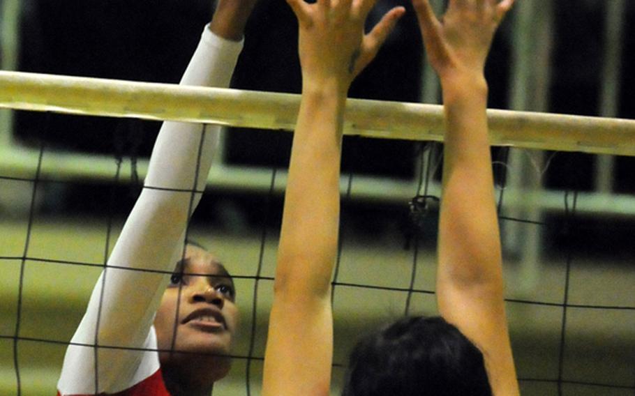 Nile C. Kinnick Red Devils middle blocker Mashiya McKinney and Seisen International Phoenix middle blocker Maya Davis battle for the ball at the net during Tuesday's Kanto Plain Association of Secondary Schools girls volleyball match at the Phoenix Center, Seisen International School, Tokyo.