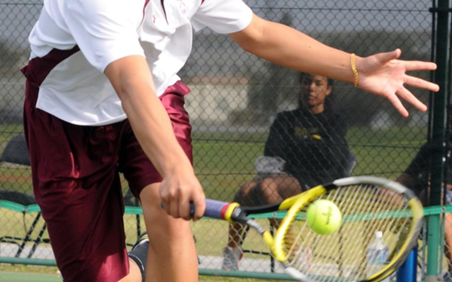 Jon Cadavos of Matthew C. Perry lunges to hit a backhand shot at Daniel Boyle of Zama American during the first-round boys singles match in the Far East High School Tennis Tournament at Kadena Air Base, Okinawa on Nov. 5, 2012. Cadavos beat Boyle 8-2, less than 24 hours after he, five teammates and coach Mark Lange survived a harrowing aborted landing attempt in a thunderstorm on approach to Naha International Airport aboard All-Nippon Airways Flight 977 from Hiroshima.