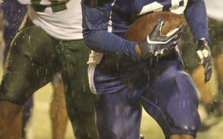 Yokota running back Donovan Ball dashes away from Kubasaki defender Kareem Key during Saturday's Far East High School Division I football championship game at Yokota Air Base, Japan. Yokota won 55-8 for its second straight D-I title.