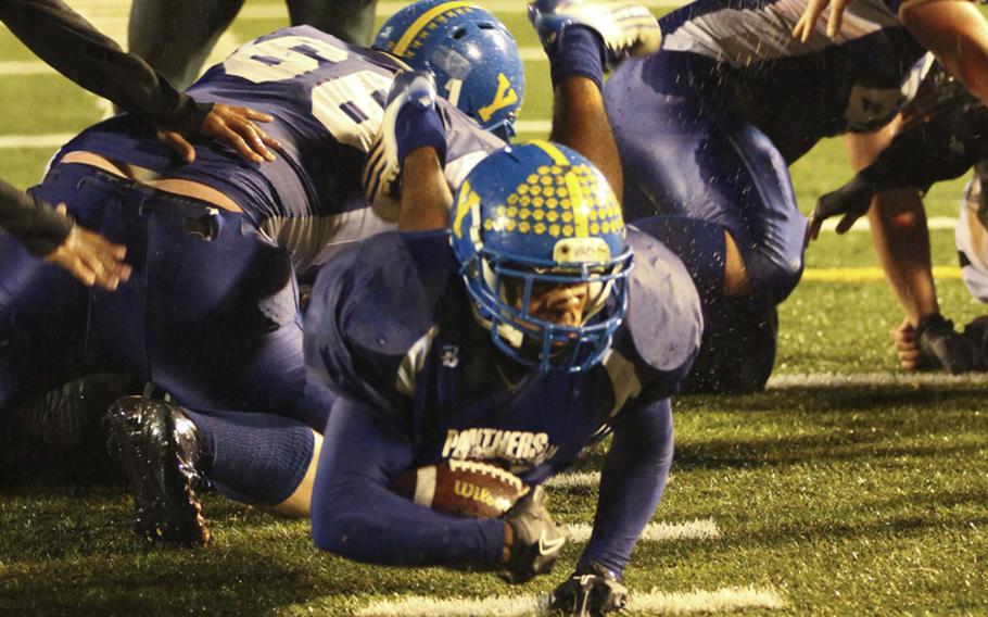 Yokota running back Raymond Butler dives for the end zone against Kubasaki during Saturday's Far East High School Division I football championship game at Yokota Air Base, Japan. Yokota won 55-8 for its second straight D-I title.