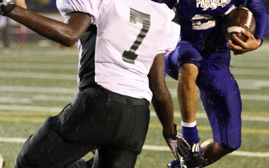 Yokota running back Donovan Ball looks to run past Kubasaki defender Jamal Ellis during Saturday's Far East High School Division I football championship game at Yokota Air Base, Japan. Yokota won 55-8 for its second straight D-I title.