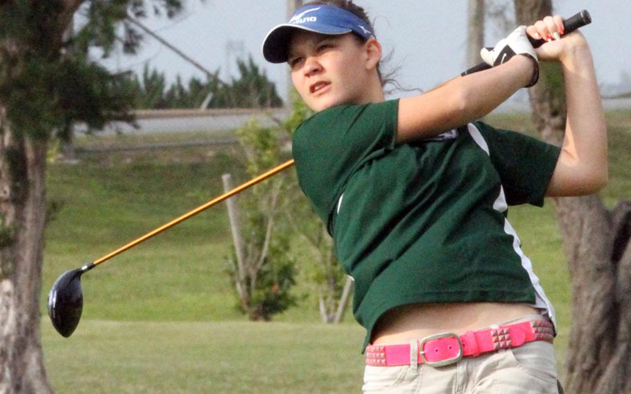 Kubasaki Dragons' Terah Whitehurst eyes her tee shot during the Okinawa Activities Council golf match March 14, 2013, at Kadena Air Base, Okinawa. Whitehurst beat Kadena's Zoe Stenovitch 49-51, 2 up and Kubasaki and Kadena halved the meet 1-1 as a team.