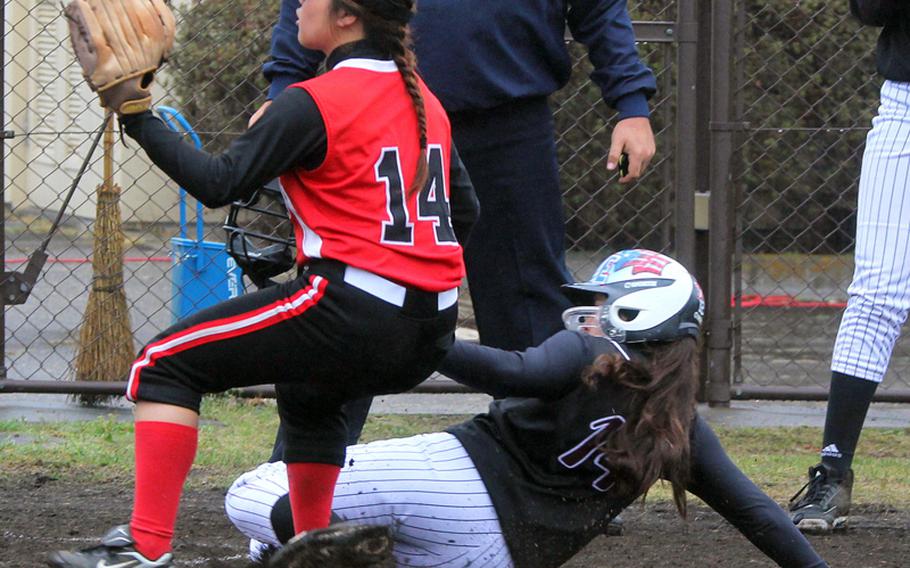 Zama American baserunner Nicole Oquendo slides in safely at home as E.J. King pitcher Deanna Austin tries to cover the plate during Saturday's DODDS Japan softball tournament at Yokota Air Base, Japan. Zama, the reigning Far East Division II Tournament champion, won 17-6 in two innings.