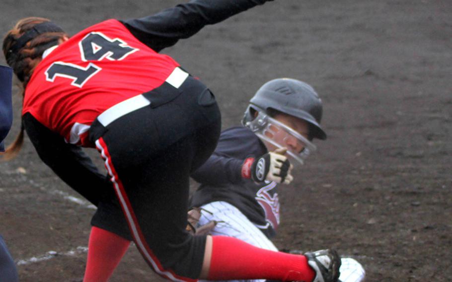 Zama American baserunner Melissa Sybico slides in safely at home under the tag of E.J. King's Deanna Austin during Saturday's DODDS Japan softball tournament at Yokota Air Base, Japan. Zama, the reigning Far East Division II Tournament champion, won 17-6 in two innings.
