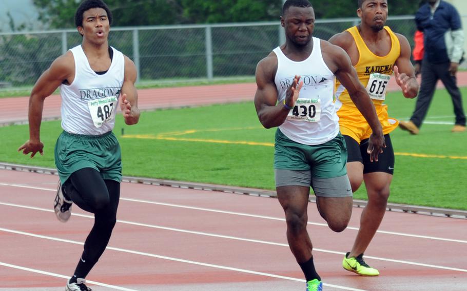 Kubasaki's Rahman Farnell and Jarrett Mitchell and Kadena's Diante Lora lead the pack in the boys 100-meter dash during Saturday's second day of competition in the 10th Alva W. "Mike" Petty Memorial Track and Field Meet at Kadena Air Base, Okinawa. Farnell rallied to win the event in a wind-aided 10.94 seconds. Mitchell was second in 11.00 and Lora third in 11.64.