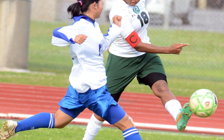Kubasaki's Sydney Johnson sends the ball toward the goal past a Shuri High School defender during Friday's girls soccer match at Camp Foster, Okinawa. The Dragons won 2-0.