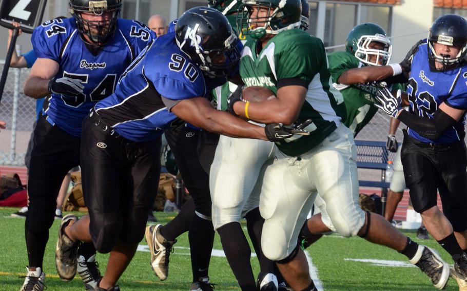 Hansen Wolfpack running back Early Neal collides with Kadena Dragons defensive end Justin Lassiter (90) during Saturday's U.S. Forces Japan-American Football League game at Ryukyu Middle School, Kadena Air Base, Okinawa.