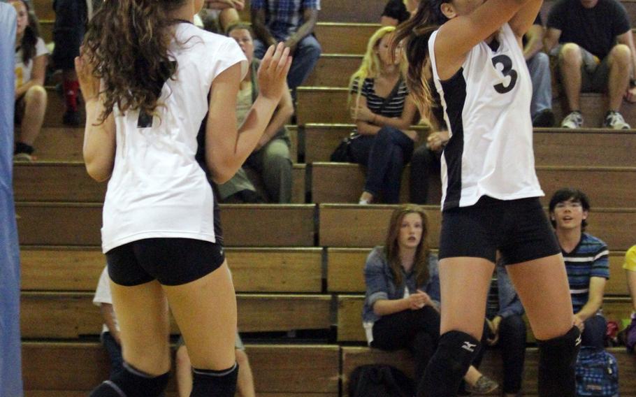Kadena middle blocker Nia Rodriguez bumps the ball as teammate Mia Savoy watches during Tuesday's Okinawa Activities Council regular-season girls volleyball opener at Kadena Air Base, Okinawa. Kadena rallied to beat Kubasaki 23-25, 25-18, 15-25, 25-12, 15-11.