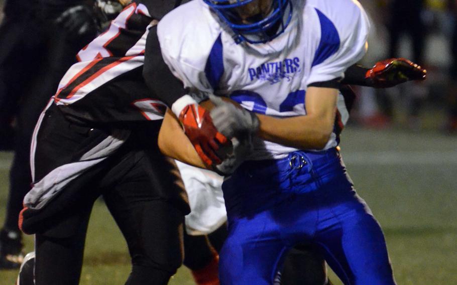 Yokota freshman running back Clay Brownell gets pursued by the Nile C. Kinnick defense during Friday's DODDS Japan-Kanto Plain Association of Secondary Schools Division I football game at Yokosuka Naval Base, Japan. The Red Devils won 55-27, their first win over the Panthers since Oct. 16, 1998.