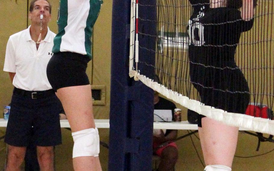 Daegu setter Kaitlyn Nott battles Ashley Becker of Osan at the net during Saturday's Korean-American Interscholastic Activities Conference girls volleyball match at Camp George, South Korea. The Warriors won for the seventh time this season, all in straight sets.