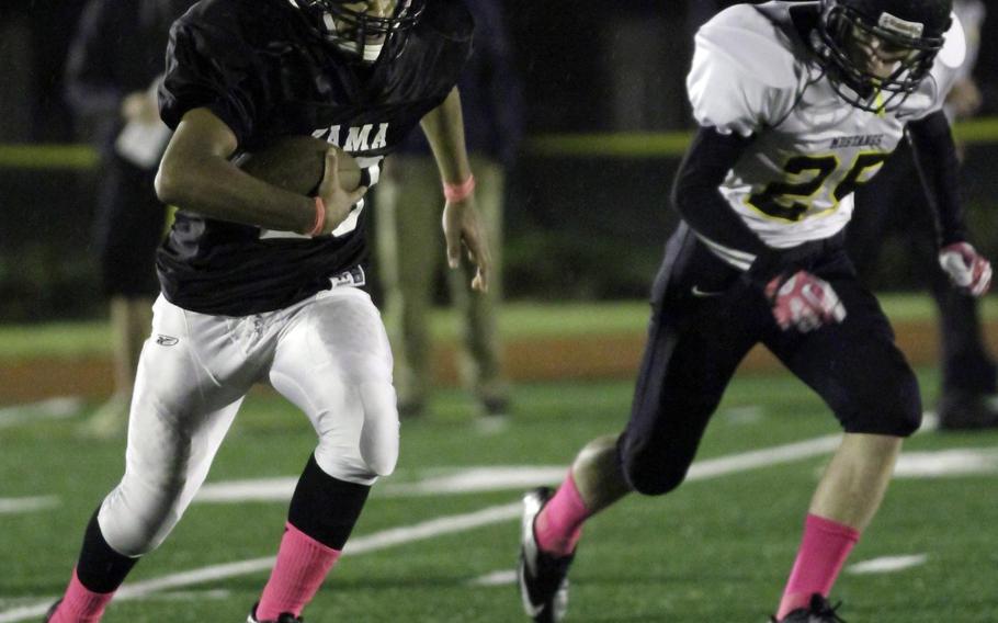 Zama American running back Rafael Morales tries to avoid the defense of American School In Japans Joseph Walker during Friday's Kanto Plain Association of Secondary Schools football game at Naval Air Facility Atsugi, Japan. ASIJ won 35-6, improving to 5-0 this season.