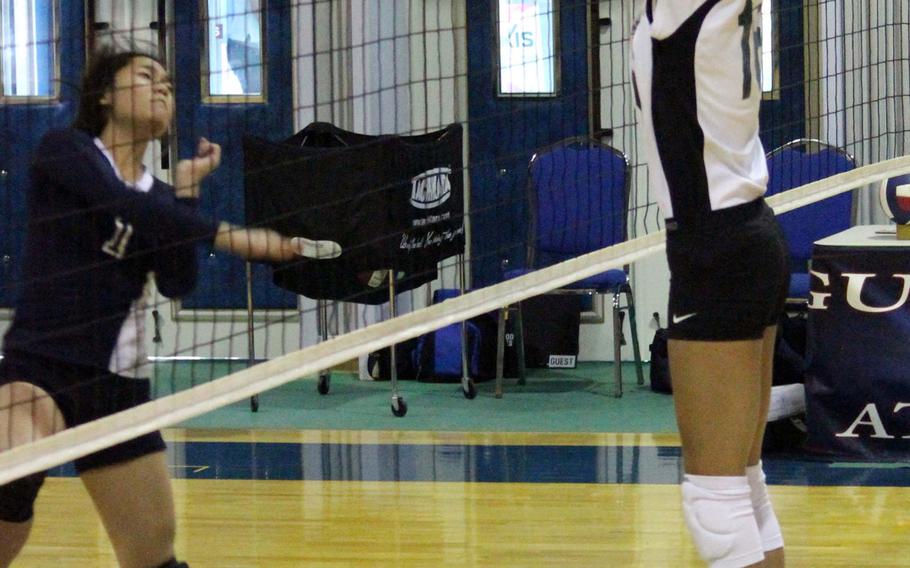 Daegu middle blocker Auburn Hood blocks a spike attempt by Jessica Jun of Yongsan International-Seoul during Saturday's Korean-American Interscholastic Activities Conference Blue Division girls volleyball match at Yongsan International School-Seoul. The Warriors won 13-25, 25-19, 25-20, 25-21, improving to 8-1 on the season, a day after losing their first match in four sets at Taejon Christian International School.