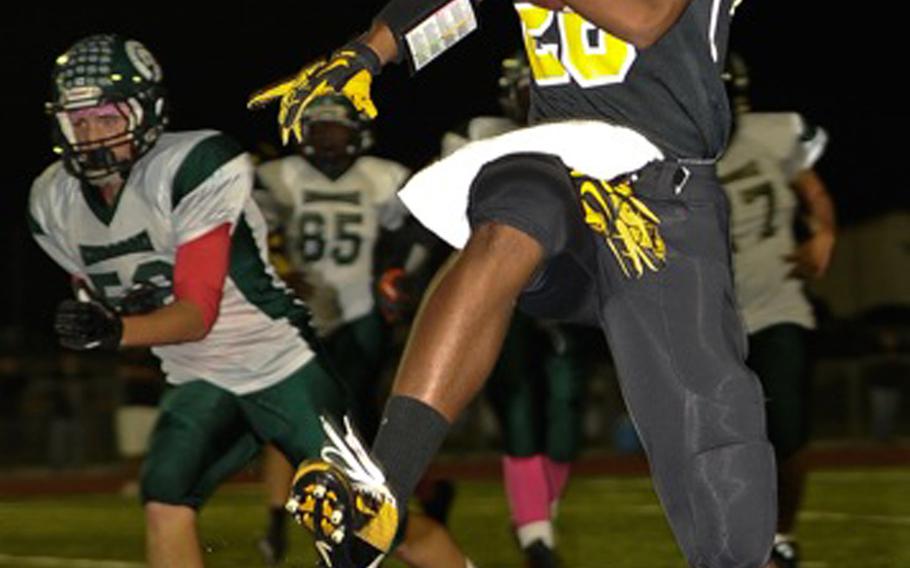 Kadena quarterback Jamario Harris outruns the Kubasaki defense during Friday's football game at Kadena Air Base, Okinawa. Kadena won 11-0, capturing its first island series since 2010.