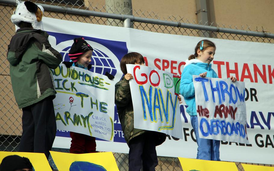 Youthful Navy fans brandish placards in support of their sailor favorites during Saturday's Korea Army-Navy flag football rivalry game at Yongsan Garrison, South Korea. The support was to no avail as the soldiers routed the sailors 62-0, improving to 14-3 in the Peninsula Trophy series.