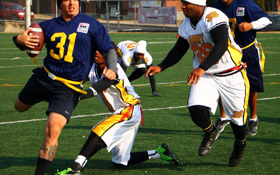 Navy's Scott Mai tries to elude two Army defenders during Saturday's Korea Army-Navy flag football rivalry game at Yongsan Garrison, South Korea. The soldiers routed the sailors 62-0, improving to 14-3 in the Peninsula Trophy series.