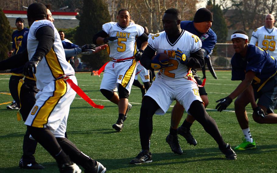 Army's Centrail Byrd looks for running room between teammates and Navy defenders during Saturday's Korea Army-Navy flag football rivalry game at Yongsan Garrison, South Korea. The soldiers routed the sailors 62-0, improving to 14-3 in the Peninsula Trophy series.