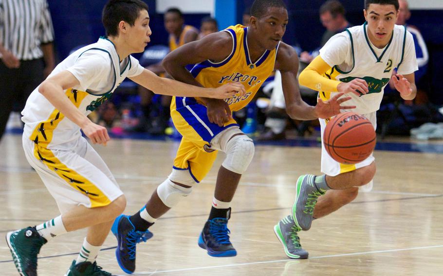 Yokota guard J.J. Henderson drives upcourt between Robert D. Edgren  defenders Joshua Sulzer and Izzy Leon during Friday's DODDS Japan boys high school basketball game at Misawa Air Base, Japan. Yokota won 70-37.