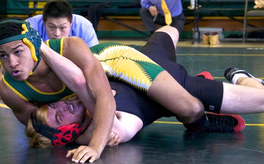 Robert D. Edgren's Kaleb Atchison gets the upper hand on E.J. King's Thomas McGrath during Saturday's DODDS Japan dual-meet tournament at Misawa Air Base, Japan. Atchison went unbeaten at 141 pounds and the Eagles won four of their five duals to finish second.