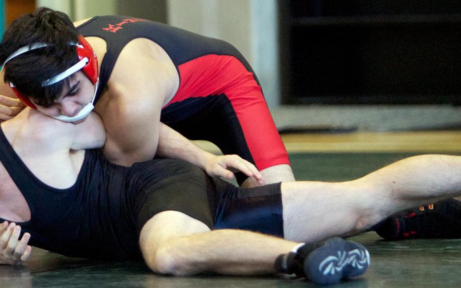 Nile C. Kinnick's Ian Olson gains the advantage on E.J. King's Thomas McGrath during Saturday's DODDS Japan dual-meet tournament at Misawa Air Base, Japan. Olson won all but one of his bouts at 141 pounds and Kinnick won all five of its duals to capture the tournament title.