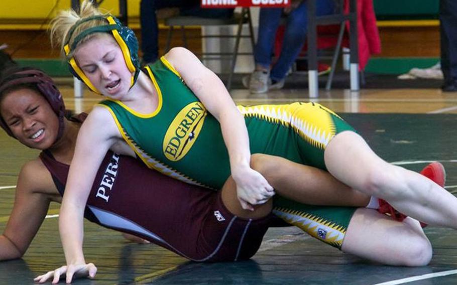 Robert D. Edgren's Halle Gregory gains the edge on Matthew C. Perry's Makela Adams during Saturday's DODDS Japan dual-meet tournament at  Misawa Air Base, Japan. Girls wrestlers are nothing new for Edgren, which has fielded as many as five in a season since Janine Kunsch debuted in 1999. Adams is the first girls wrestler in the history of Perry's three-season-old program.