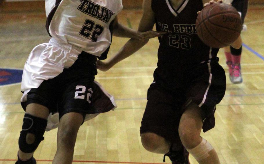 Matthew C. Perry guard Naomi Ziola dribbles against Zama American defender Tiarra Carrol during Friday's DODDS Japan high school girls basketball game at  Naval Air Facility Atsugi, Japan. Zama won 46-13.