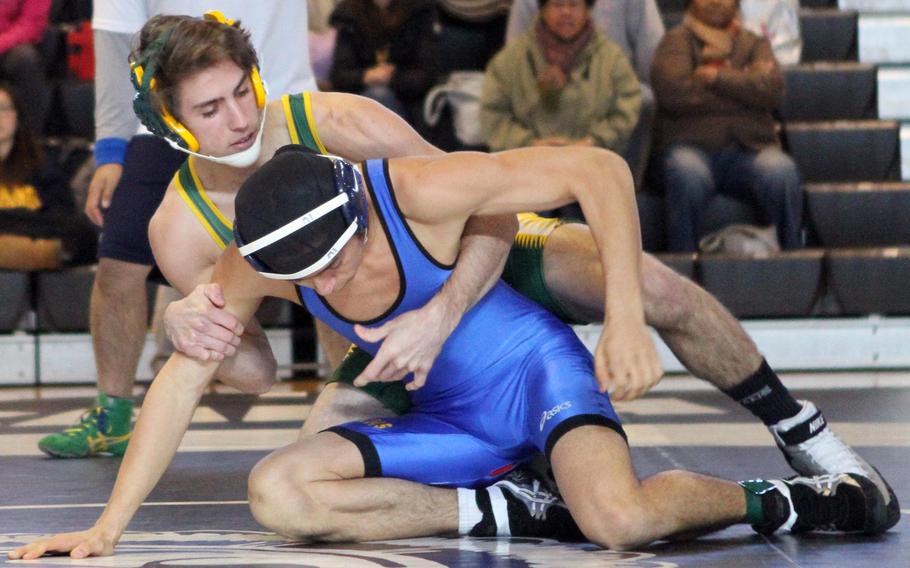 Hunter Matthews of Robert D. Edgren gains the edge on St. Mary's International's Alberto Orsawa in their 129-pound bout during Saturday's four-way dual tournament at Camp Zama, Japan. Matthew won the bout and went unbeaten on the day for the second straight week.