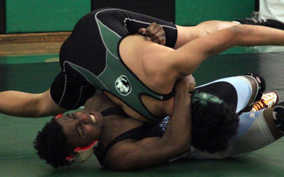 Osan American's Gerad Chopin tilts Daegu's Carl Pastor in a 141-pound bout during Saturday's five-way dual tournament at Camp George, South Korea. Chopin won by technical fall 12-3. The teams tied 27-27, but Daegu won by virtue of having more pinfall victories.