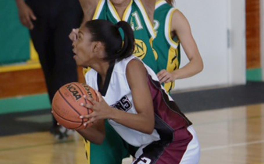 Zama American's Ajane Williams looks to shot against Candice Miller of Robert D. Edgren during Saturday's DODDS Japan girls high school basketball game at Misawa Air Base, Japan. The Trojans won 58-51 in overtime.