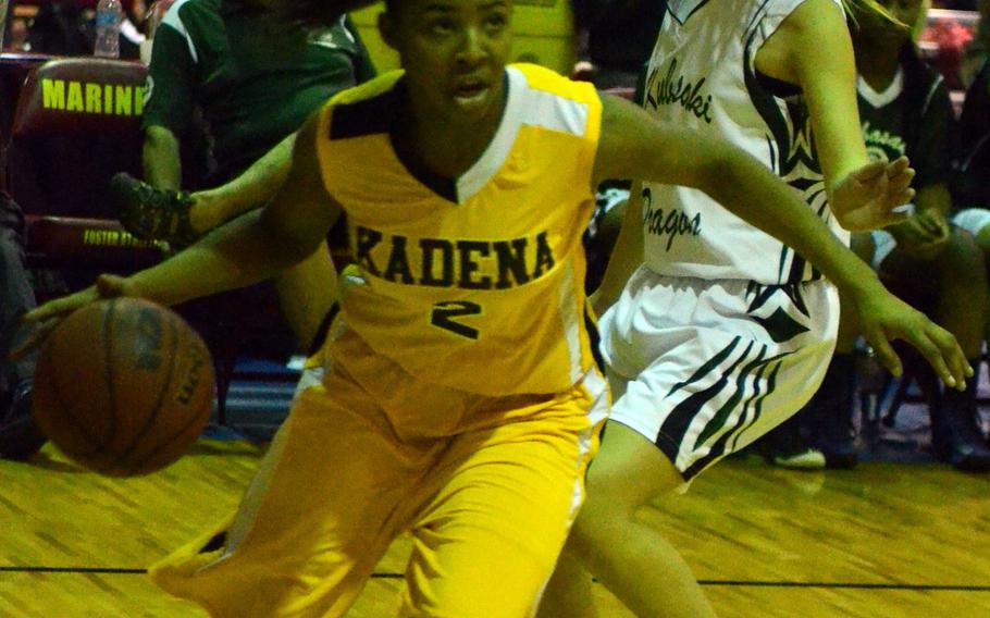Kadena junior Jasmine Rhodes dribbles past Kubasaki's Leigh Trumble to the basket during Sunday's knockout game in the 20th Martin Luther King Invitational Basketball Tournament at Marine Corps Air Station Futenma, Okinawa. Rhodes scored 32 points, 23 in the first half alone, as Kadena routed Kubasaki 63-40.

