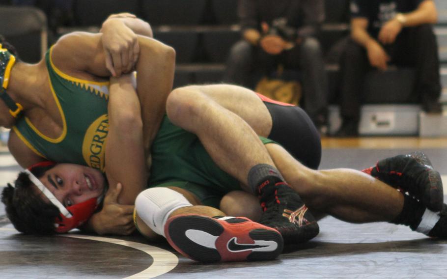 Robert D. Edgren's 141-pounder Kaleb Atchison gets a head-and-arm hold on Nile C. Kinnick's Ian Olson Saturday, during a DODDS Japan individual freestyle wrestling tournament bout at Camp Zama, Japan. Atchison beat Olson for first place.